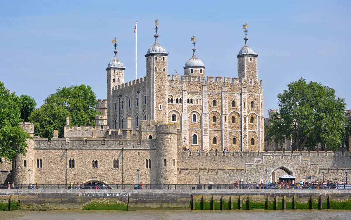 De Tower of London gezien vanaf de oever van de Theems, met Tower Bridge op de achtergrond